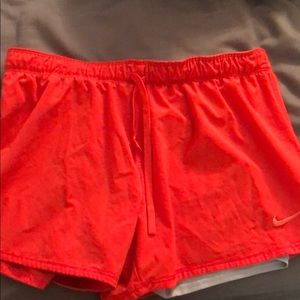 Red Nike shorts with built in spandex